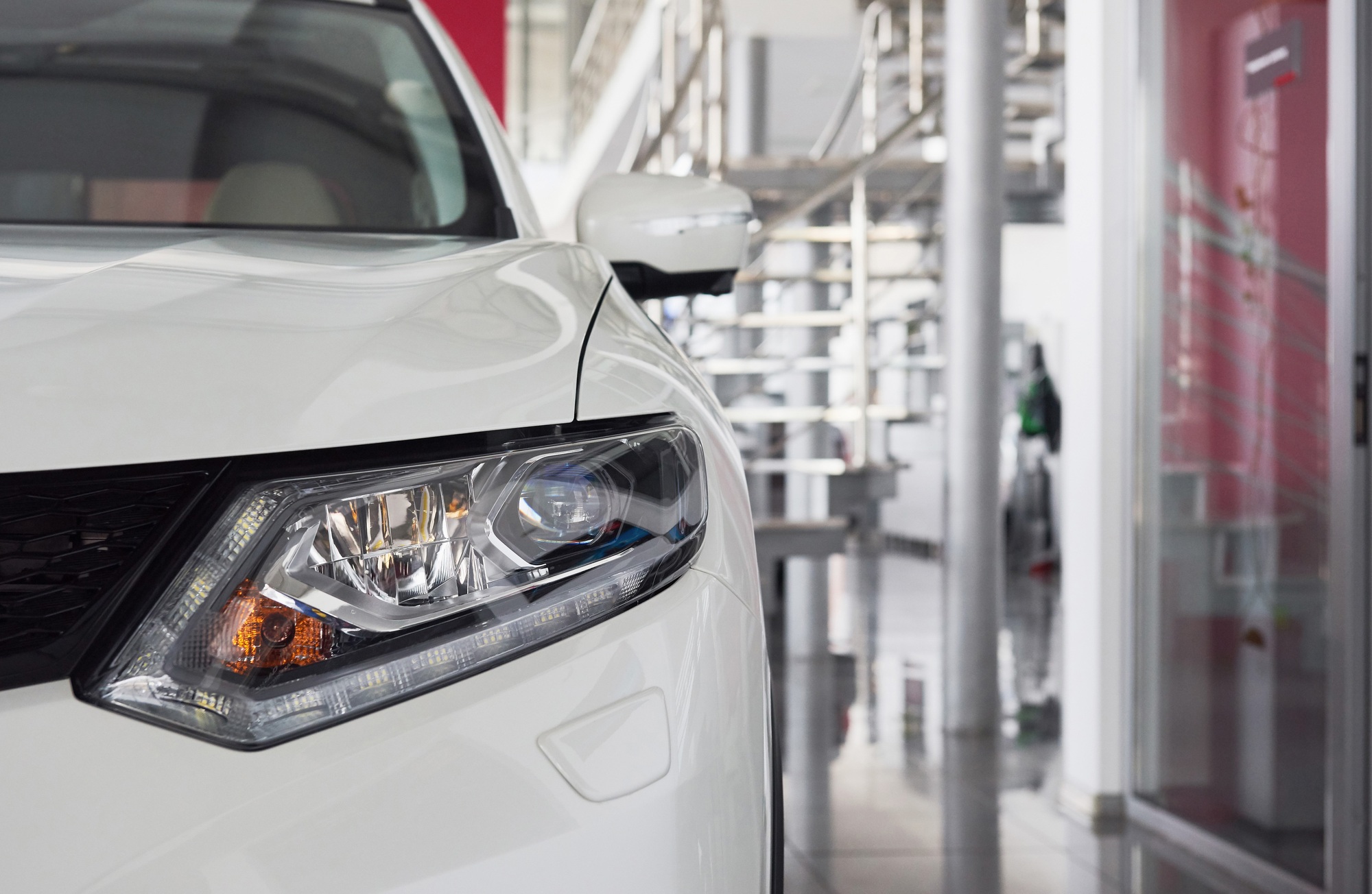 The headlights and the hood of a new luxury car